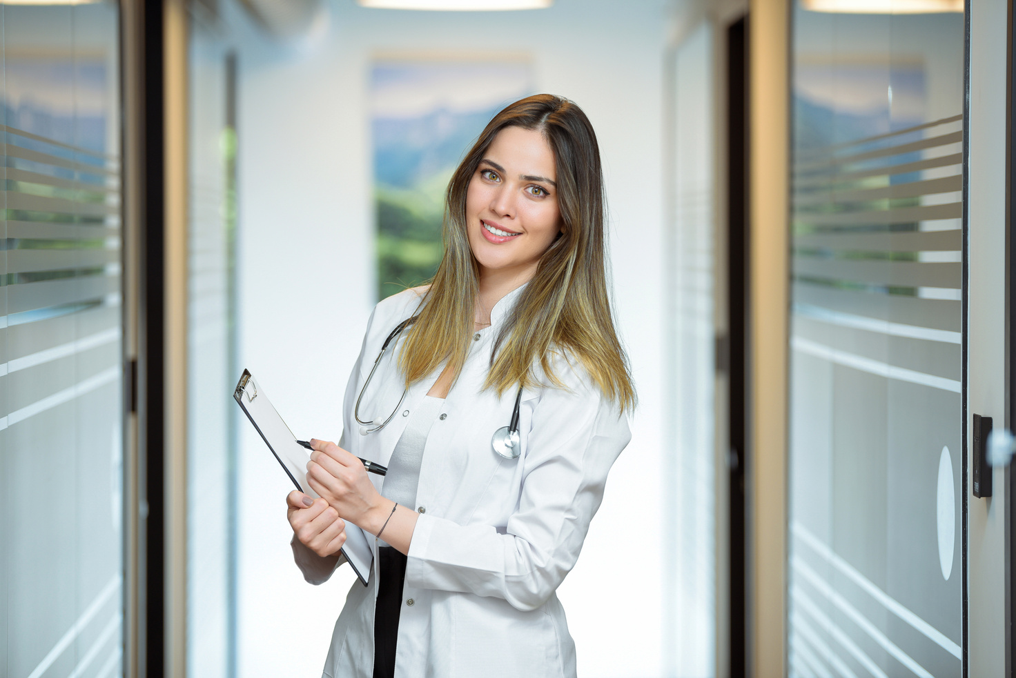 Young female doctor holding medical records